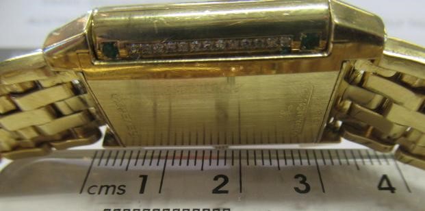 A LADY'S JAEGER-LECOULTRE EMERALD AND DIAMOND REVERSO WRISTWATCH/BRACELET Image