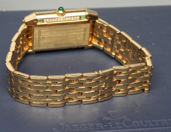 A LADY'S JAEGER-LECOULTRE EMERALD AND DIAMOND REVERSO WRISTWATCH/BRACELET Image