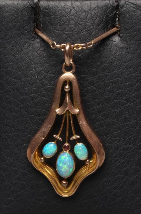 A MURRLE BENNETT PENDANT of shaped open form centred by three open back collet set oval cabochon Image