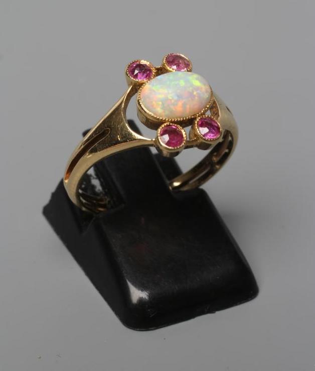 A MURRLE BENNETT DRESS RING, the oval cabochon polished opal collet set with two pairs of small Image