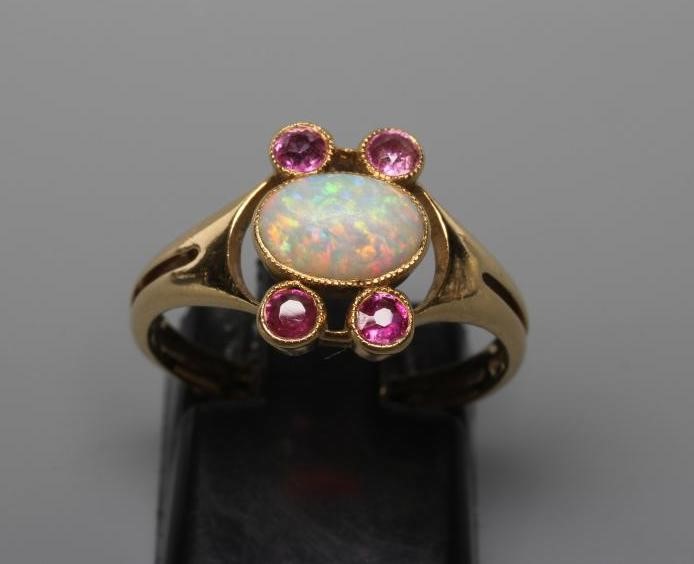 A MURRLE BENNETT DRESS RING, the oval cabochon polished opal collet set with two pairs of small Image