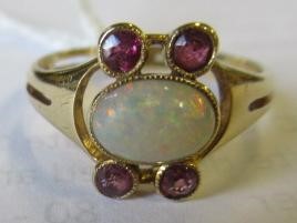 A MURRLE BENNETT DRESS RING, the oval cabochon polished opal collet set with two pairs of small Image