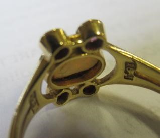 A MURRLE BENNETT DRESS RING, the oval cabochon polished opal collet set with two pairs of small Image