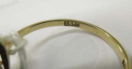 T. GAUNT - a black opal ring, the oval cabochon polished stone claw set to a plain shank, stamped Image