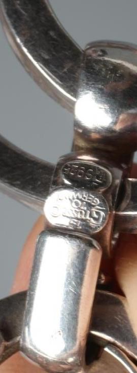 A GROSSE OF GERMANY SILVER PENDANT comprising two concentric circlets loose in mount on a fixed Image