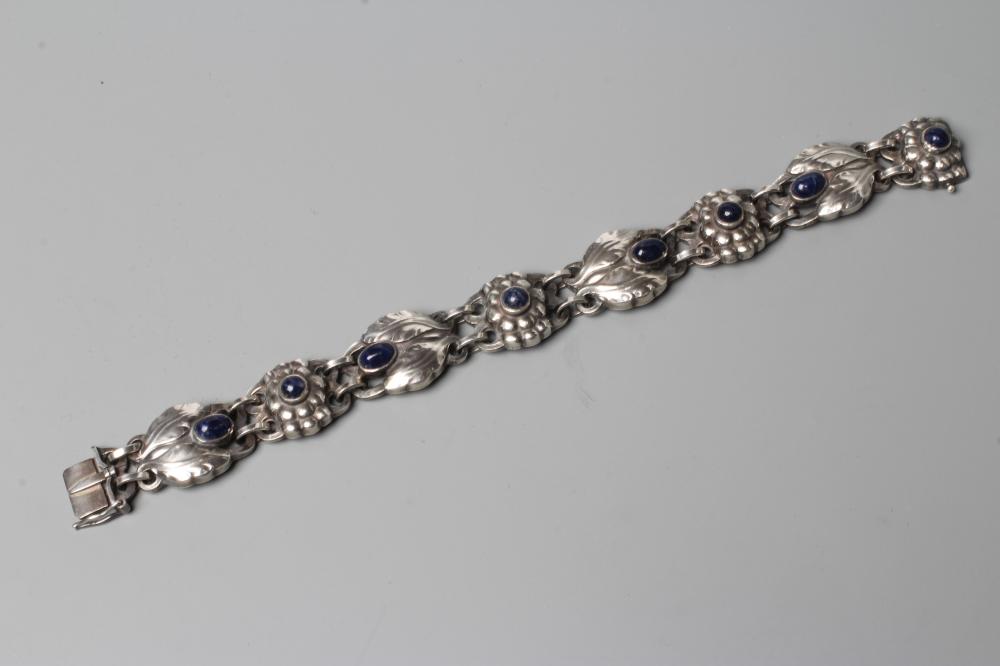 A BRACELET to match the previous lot, collet set with cabochon polished blue hardstones, stamped and Image