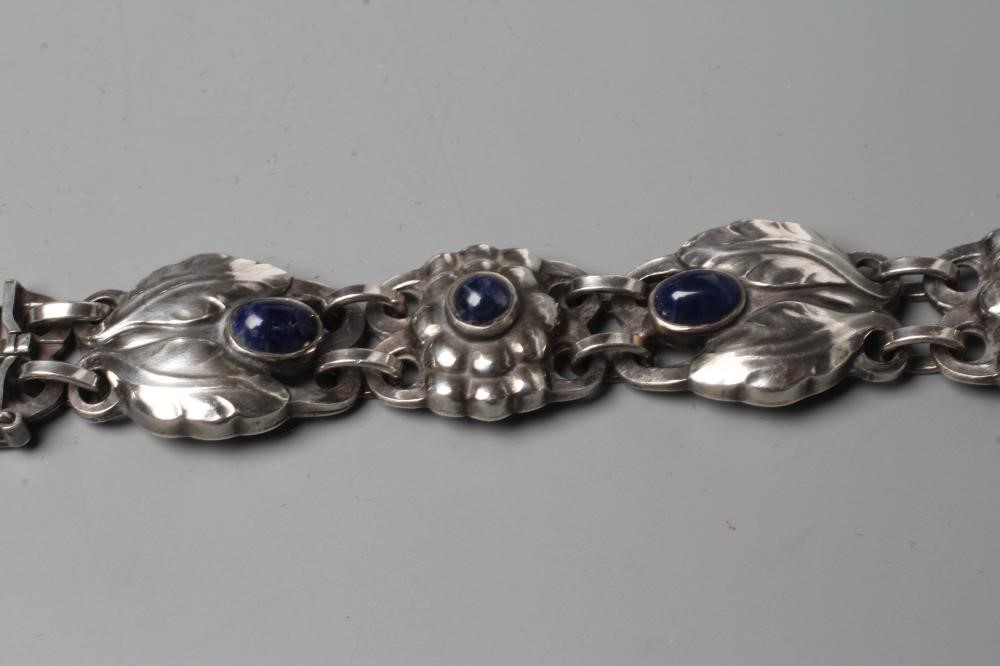 A BRACELET to match the previous lot, collet set with cabochon polished blue hardstones, stamped and Image
