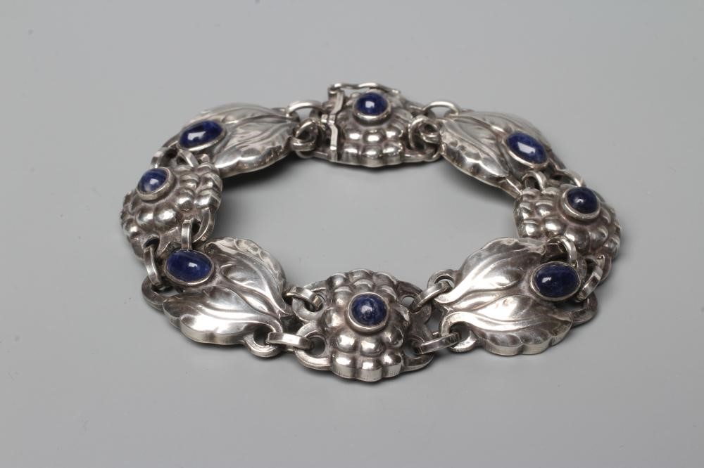 A BRACELET to match the previous lot, collet set with cabochon polished blue hardstones, stamped and Image