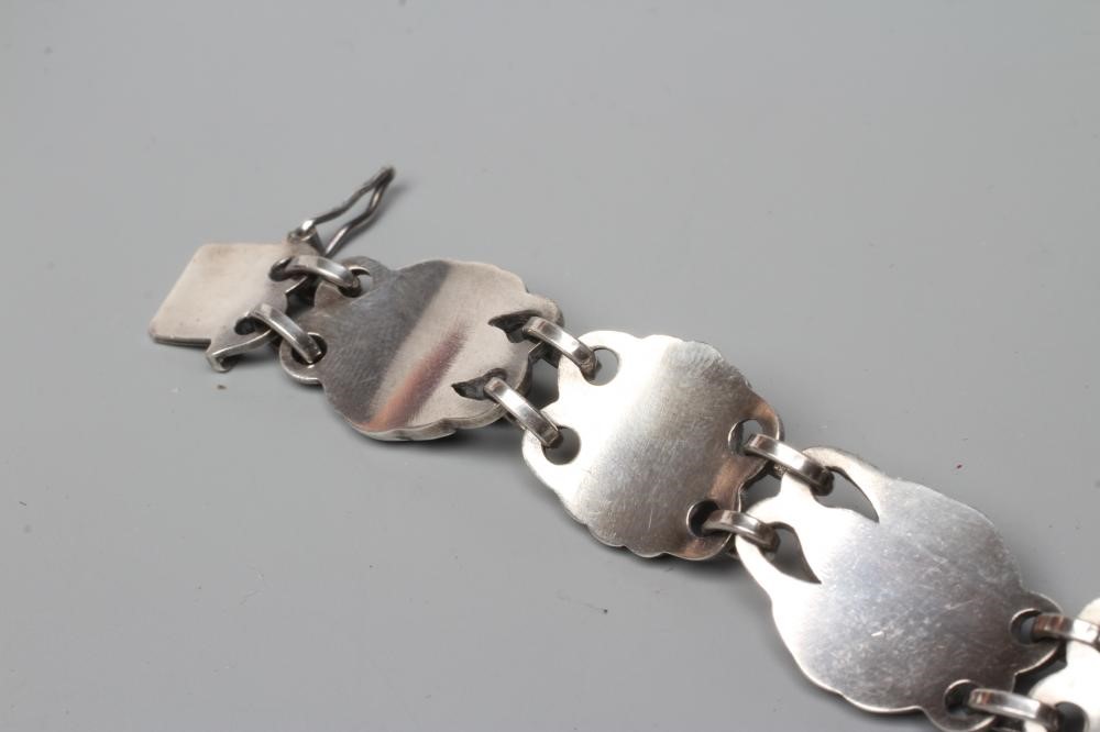 A BRACELET to match the previous lot, collet set with cabochon polished blue hardstones, stamped and Image