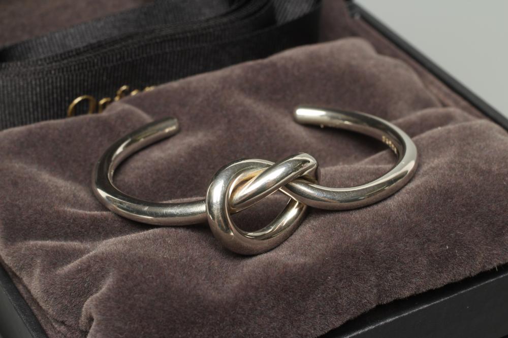A GEORG JENSEN SILVER LOVE KNOT BANGLE, numbered A44BS, cased and boxed (Est. plus 24% premium inc. Image
