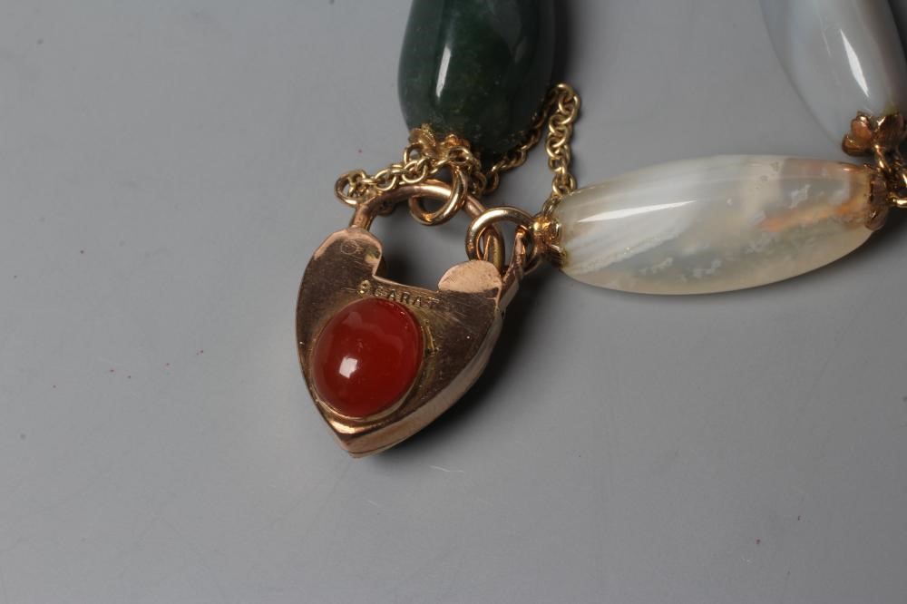 A VICTORIAN SCOTTISH PEBBLE BRACELET, the seven polished stones with unmarked metal links between Image