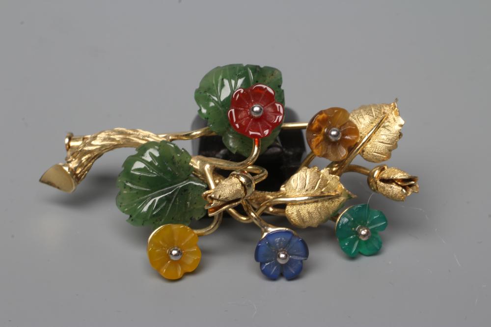 A TUTTI-FRUTTI SPRAY BROOCH, stamped 585, with carved and polished semi precious flowerheads and Image