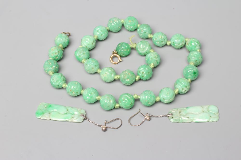 A CHINESE JADE NECKLACE, the twenty nine spherical beads carved and pierced with scrolling foliage, Image