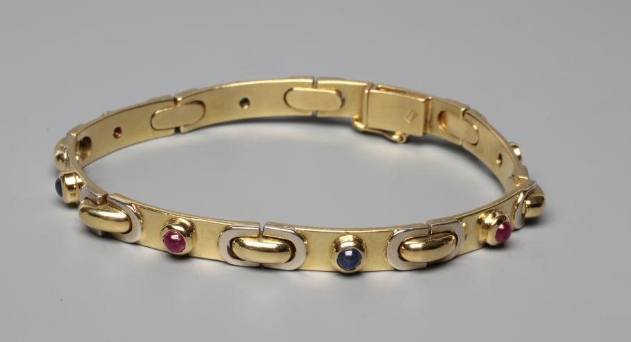 A BRACELET stamped 750, the seven slightly convex oblong panels alternately set with a cabochon Image