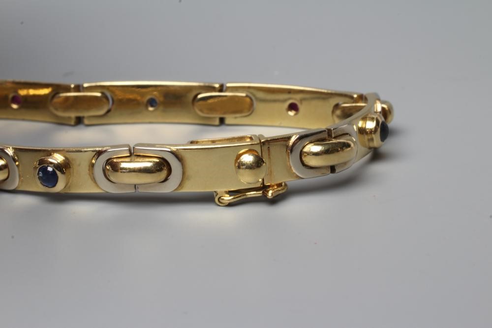A BRACELET stamped 750, the seven slightly convex oblong panels alternately set with a cabochon Image