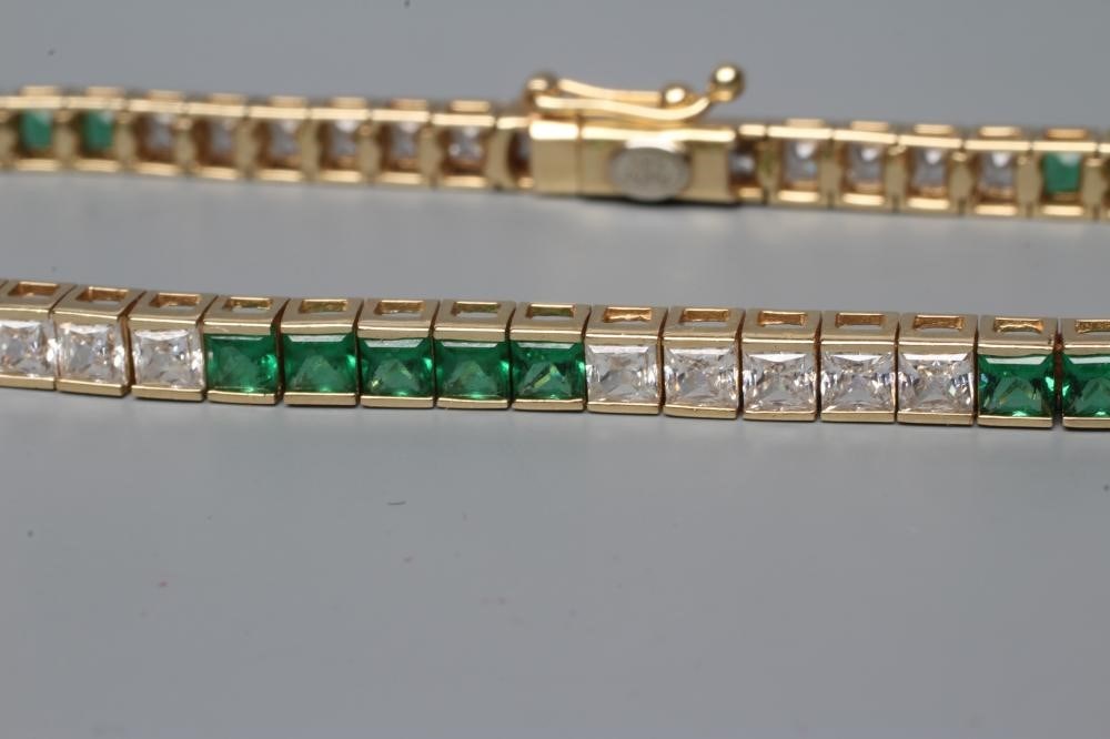 A TENNIS BRACELET bar set with five sets of five square cut green and white pastes Image