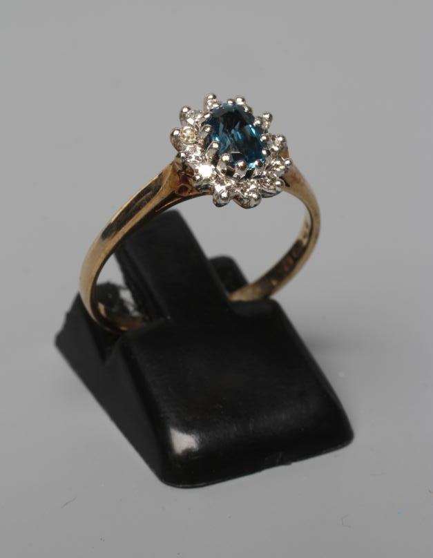 A BLUE TOPAZ AND DIAMOND CLUSTER RING Image