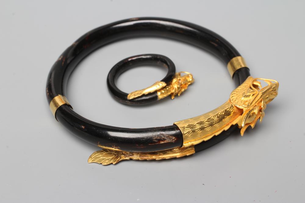 A BANGLE AND MATCHING RING, probably Chinese, possibly lacquered wood, each with a yellow metal Image