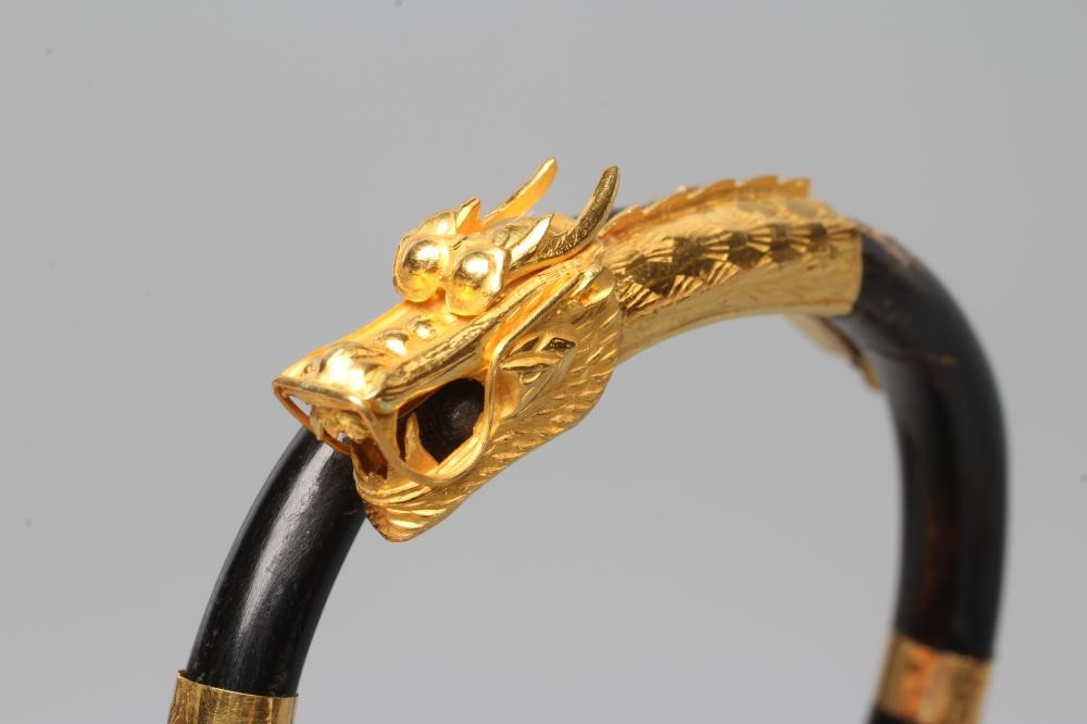 A BANGLE AND MATCHING RING, probably Chinese, possibly lacquered wood, each with a yellow metal Image