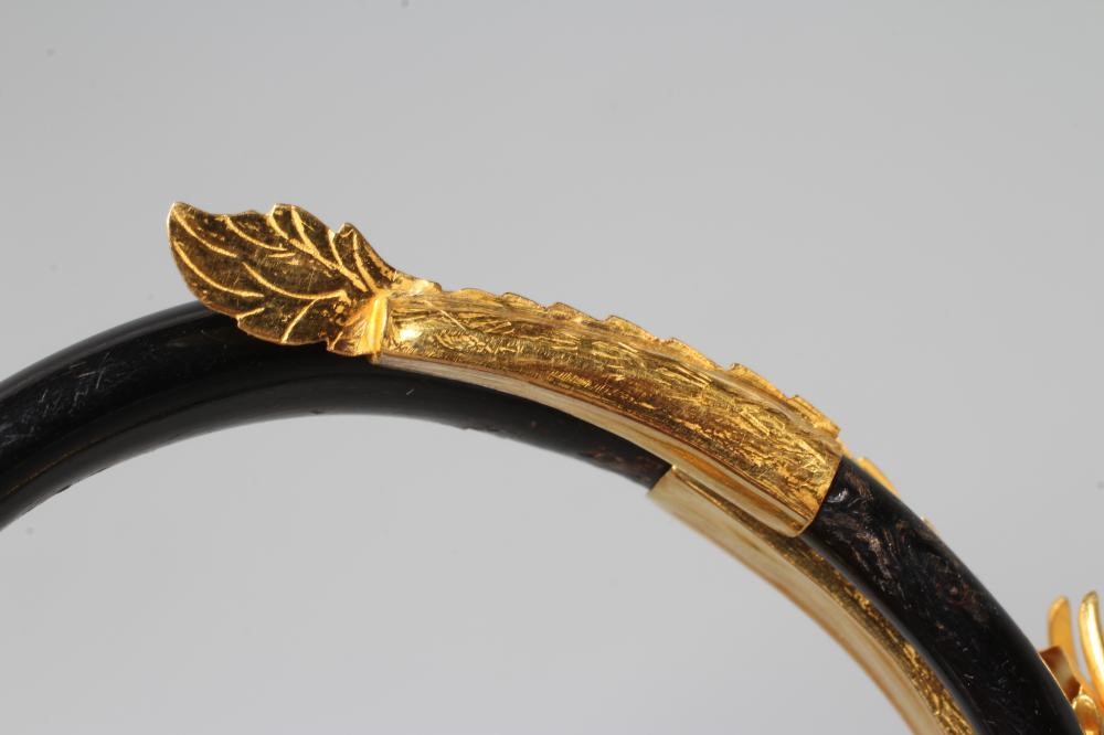 A BANGLE AND MATCHING RING, probably Chinese, possibly lacquered wood, each with a yellow metal Image