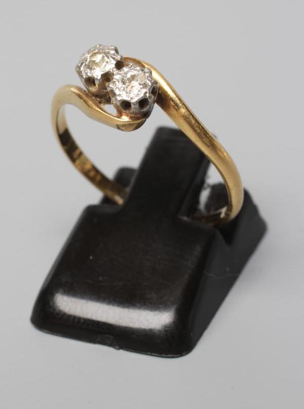 A TWO STONE DIAMOND CROSSOVER RING, the illusion set stones to a plain shank, stamped 18ct Plat, Image