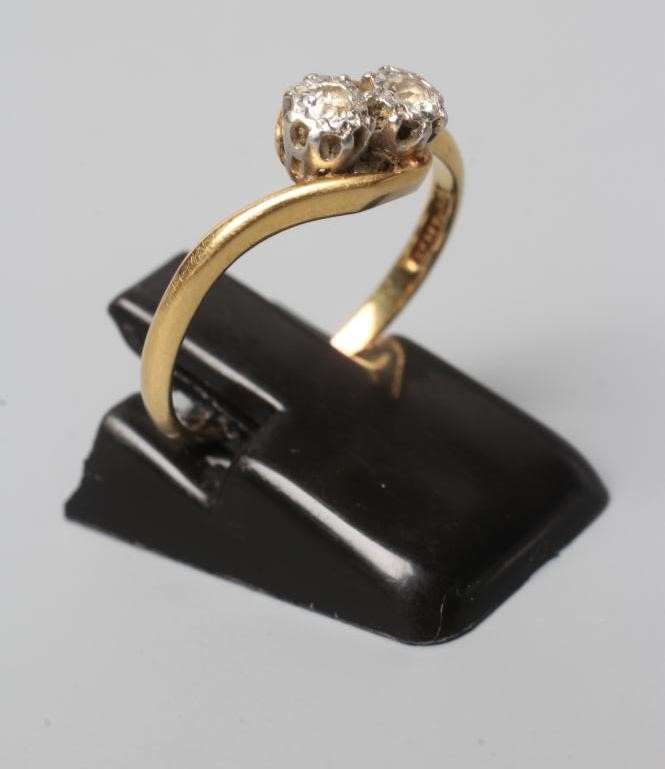 A TWO STONE DIAMOND CROSSOVER RING, the illusion set stones to a plain shank, stamped 18ct Plat, Image