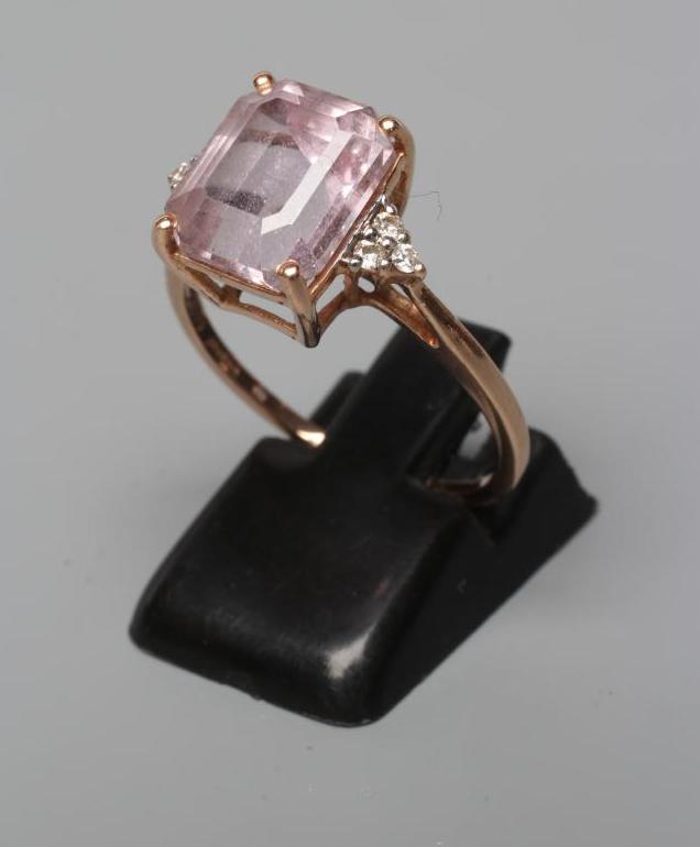 A KUNZITE AND DIAMOND DRESS RING, the oblong cut Kunzite claw set and with three small round Image
