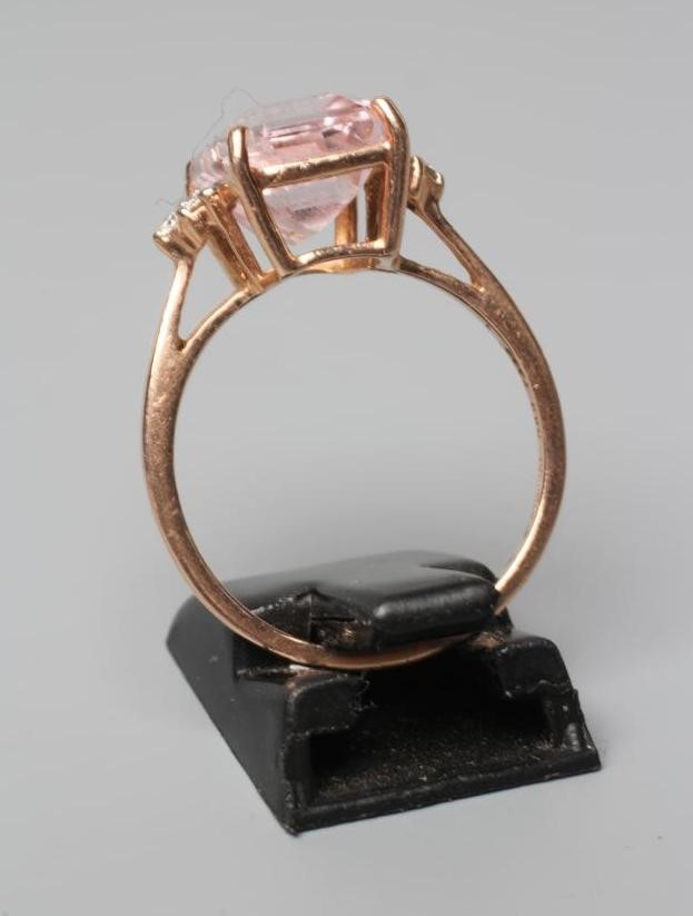 A KUNZITE AND DIAMOND DRESS RING, the oblong cut Kunzite claw set and with three small round Image