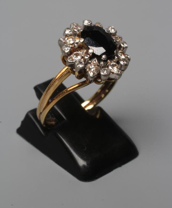 A SAPPHIRE AND DIAMOND CLUSTER RING Image