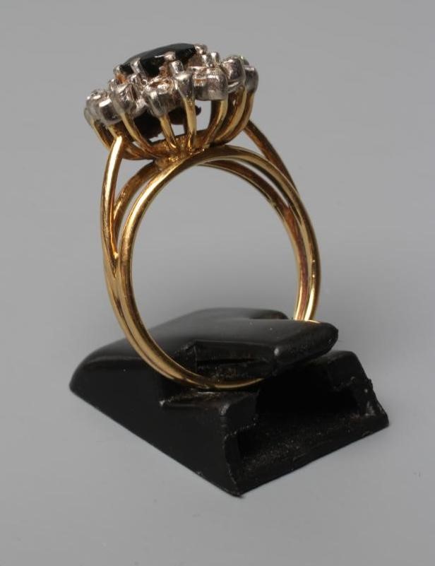 A SAPPHIRE AND DIAMOND CLUSTER RING Image