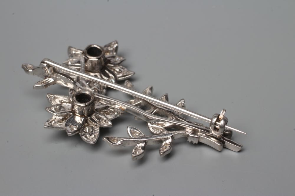 A DIAMOND FLOWER SPRAY BROOCH, the two flowerhead clusters with three leafy branches to an unmarked Image