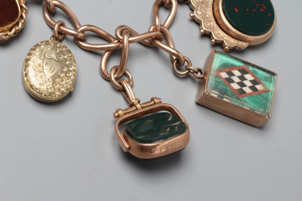 A 9CT GOLD CHARM BRACELET hung with a loose mounted 1912 sovereign Image