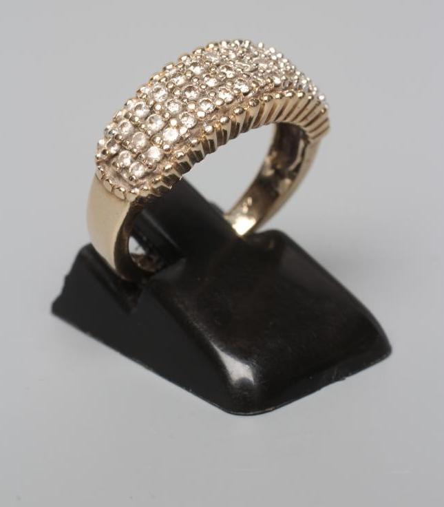 A THREE ROW DIAMOND HALF HOOP RING, the small round brilliants point set between bead borders to a Image