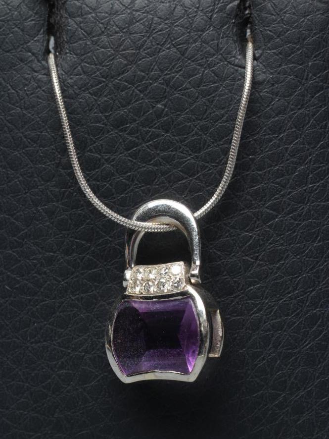 AN AMETHYST AND DIAMOND HANDBAG PENDANT Image