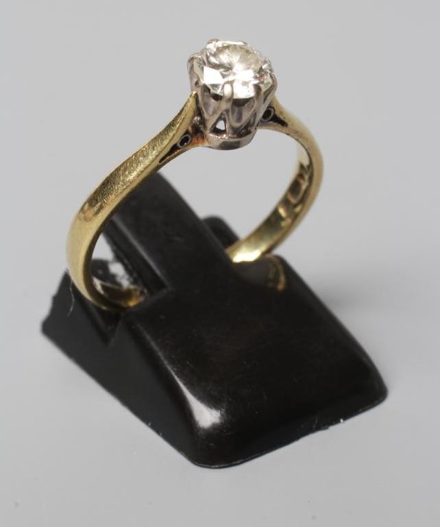 A SOLITAIRE DIAMOND RING, the round brilliant cut stone of approximately 0.60cts, claw set to a Image