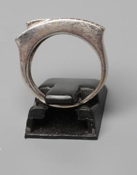 A DIAMOND CROSSOVER STYLE RING, the two panels point set with numerous small stones to a wide white Image