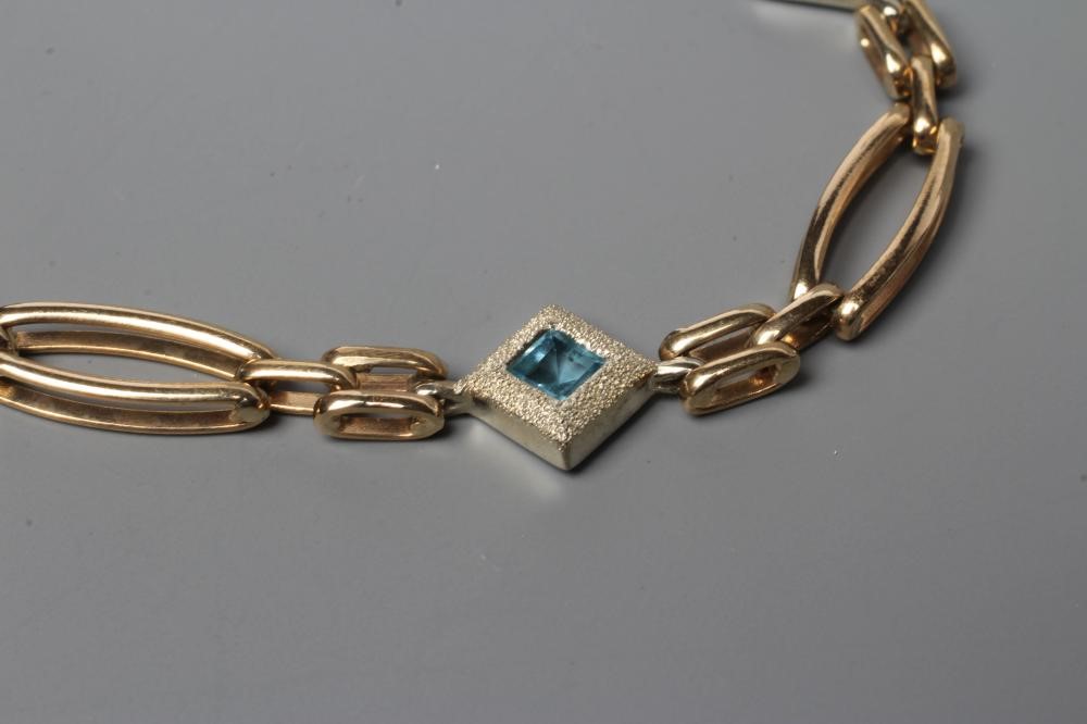 A 9CT GOLD BRACELET, the elongated oval links with four square spacers between set with a square cut Image