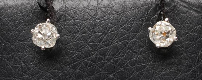 A PAIR OF SOLITAIRE DIAMOND EAR STUDS, the old cut stones totalling approximately 0.6cts claw set to Image