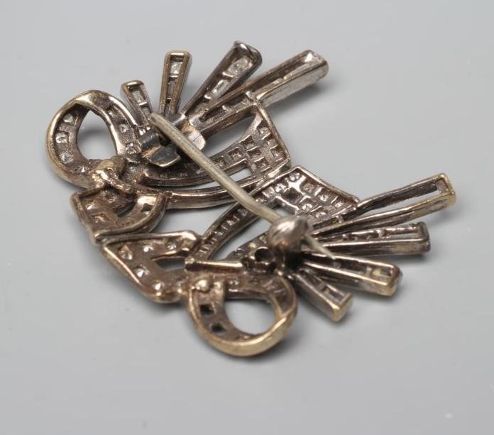 A LATE VICTORIAN DOUBLE BOW BROOCH with loops and tails pave set with numerous small stones and Image