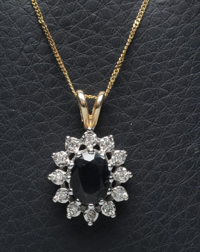 A SAPPHIRE AND DIAMOND CLUSTER PENDANT Image