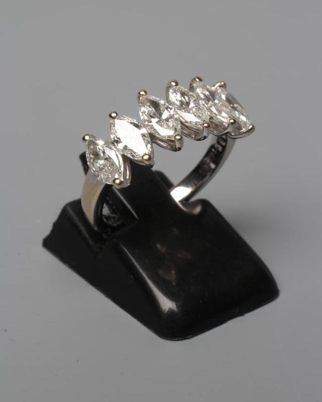 A SIX STONE DIAMOND RING, the marquise cut stones totalling 1.62cts claw set to a plain shank, Image