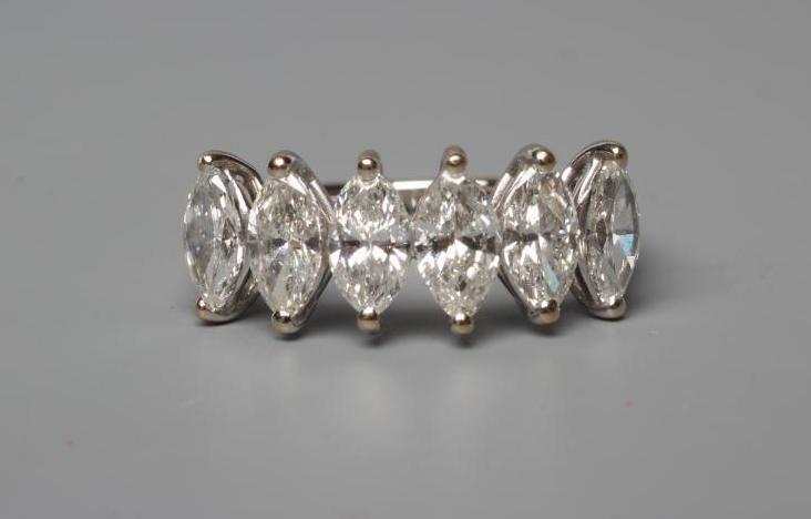 A SIX STONE DIAMOND RING, the marquise cut stones totalling 1.62cts claw set to a plain shank, Image