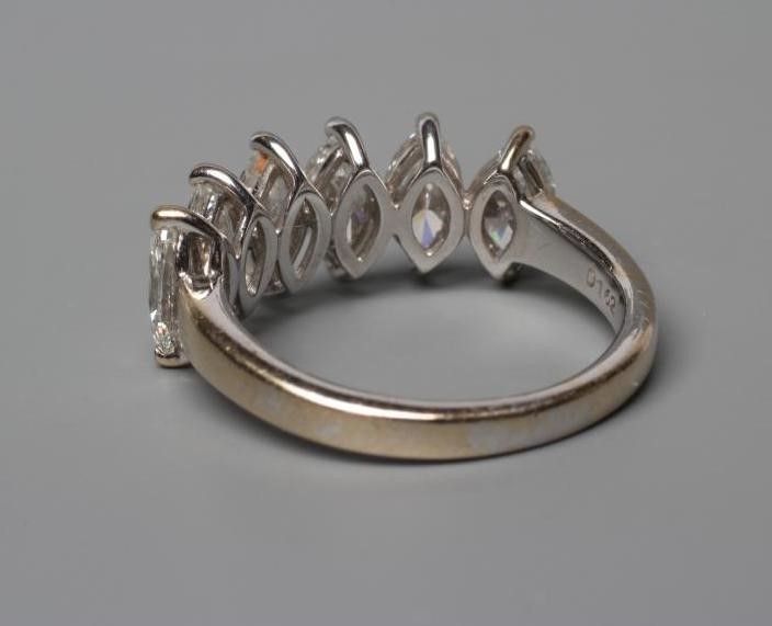 A SIX STONE DIAMOND RING, the marquise cut stones totalling 1.62cts claw set to a plain shank, Image