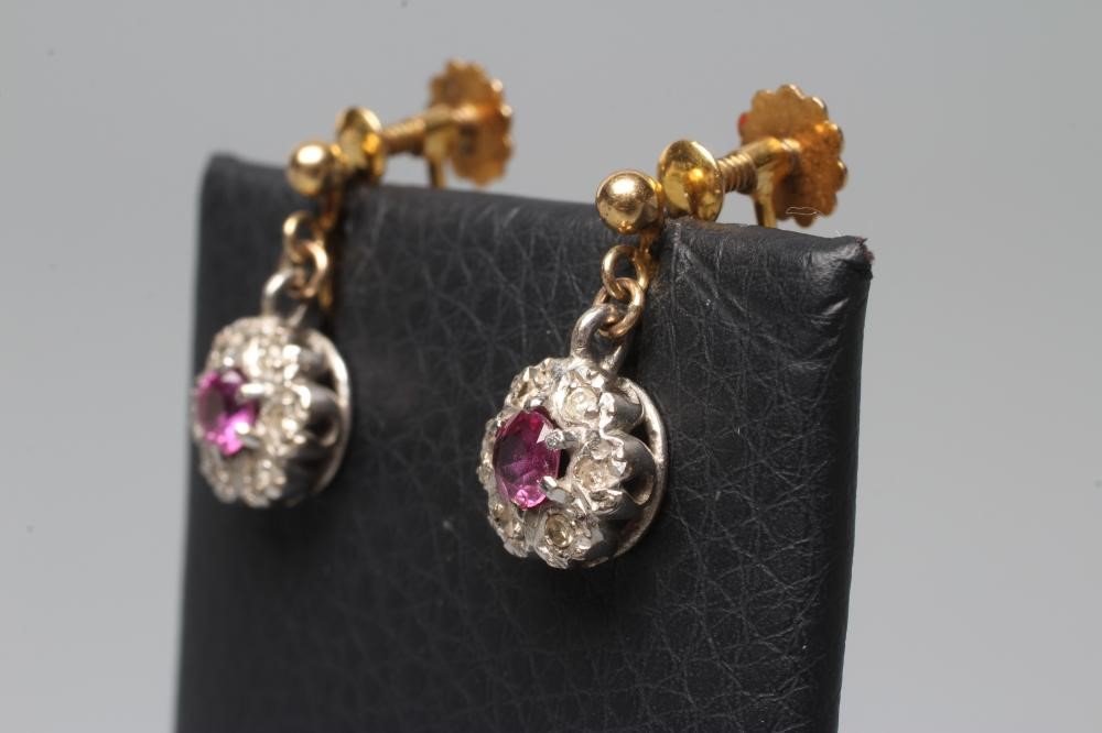 A PAIR OF EDWARDIAN RUBY AND DIAMOND CLUSTER EARRINGS on screw back fittings stamped 9ct (Est. plus Image