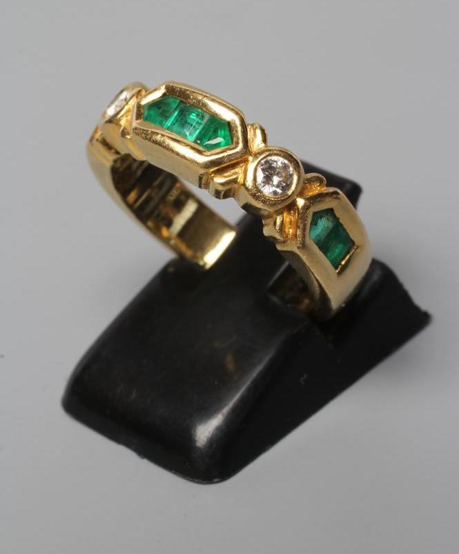 AN EMERALD AND DIAMOND HALF HOOP RING Image