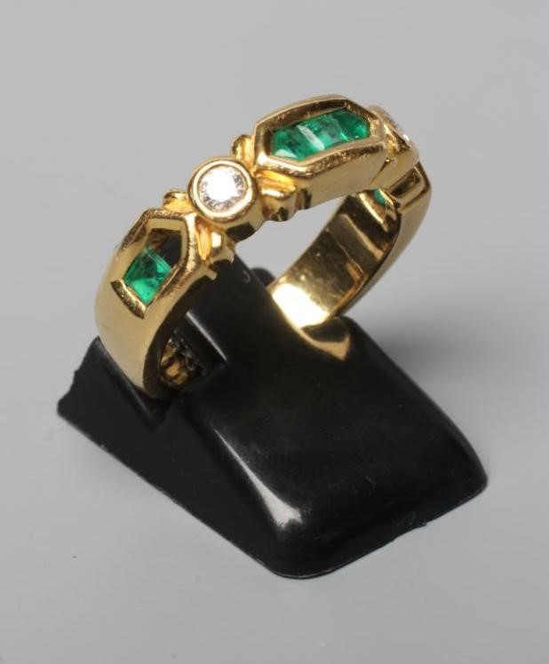 AN EMERALD AND DIAMOND HALF HOOP RING Image