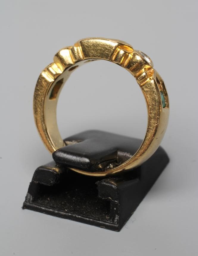 AN EMERALD AND DIAMOND HALF HOOP RING Image