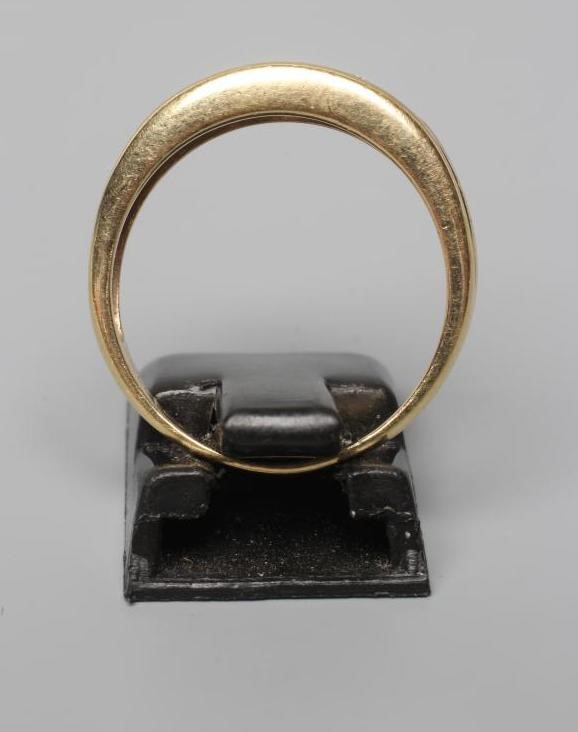 A DIAMOND HALF HOOP RING, the five graduated stones with pairs of diamond point spacers to reeded Image
