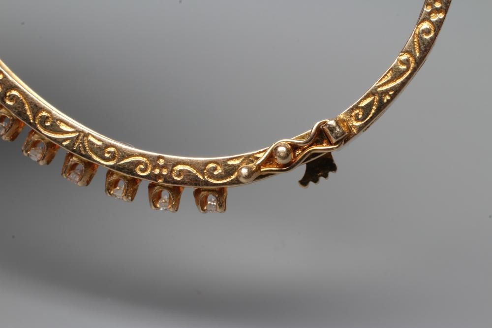 A DIAMOND SET STIFF HINGED BANGLE, the upper section claw set with seventeen small round brilliant Image