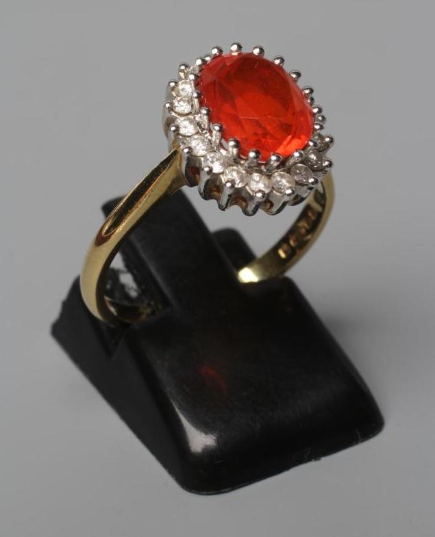 A FIRE OPAL AND DIAMOND CLUSTER RING Image